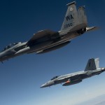 A U.S. Air Force F-15D Eagle flies next to a U.S. Navy F/A-18 Super Hornet during Midway White III over the Nevada Test and Training Range on June 26, 2012.