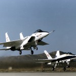 NASA's highly modified F-15 (left), used for digital electronic flight and engine control systems research, is accompanied by an F-18 chase support aircraft during its takeoff roll on a flight from the Dryden Flight Research Center, Edwards, California. The F-15A (Serial #71-0287) was called the HIDEC (Highly Integrated Digital Electronic Control) flight facility.