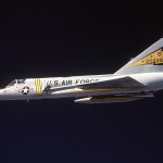 An air-to-air left side view of an F-106 Delta Dart aircraft being piloted by a squadron commander during a training mission in 1981. The aircraft are from the 5th Fighter Interceptor Squadron.