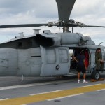 Side view of MH-60 with pilot visible. This aircraft is not stationed on the Wasp, but was parked there during Fleet Week and Independence Day festivities (Air Cache Photo/John M. Guilfoil)
