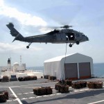 An MH-60S Sea Hawk helicopter carries one of the 333 loads of cargo from the Military Sealift Command hospital ship USNS Comfort (T-AH 20) as the ship is anchored offshore near Port-Au-Prince (US Navy photo)