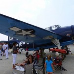 A Grumman TBF "Avenger" torpedo bomber seen at the 2012 Great New England Airshow at Westover Air Reserve Base. Crowds enjoyed the shade provided by its wings. (Air Cache photo/John M. Guilfoil)
